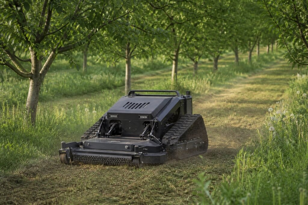 Demo tracked mower working between orchard rows